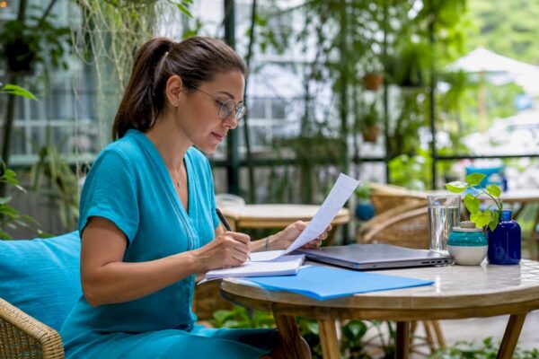 PR professional typing pitch at co-working table