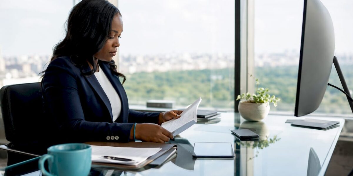 Lawyer thoughtfully reviewing documents at desk