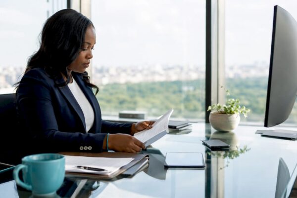 Lawyer thoughtfully reviewing documents at desk