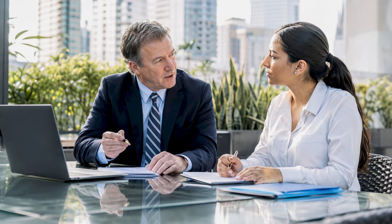 Partners discussing strategy by conference room window