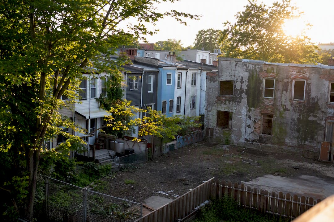 Urban street with vacant and renewed housing