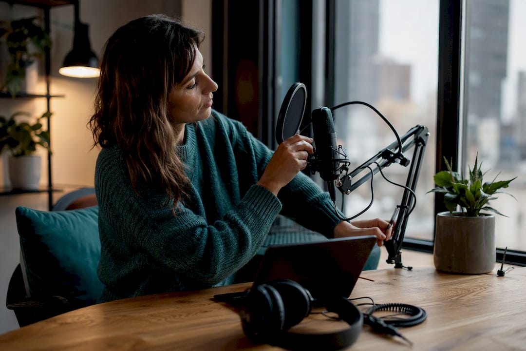 Podcast microphone being adjusted