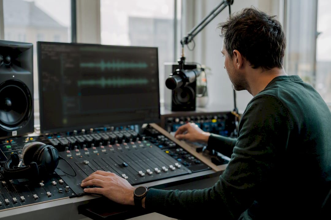 Hands editing radio audio tracks