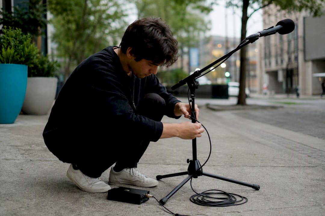 Person setting up public address speaker
